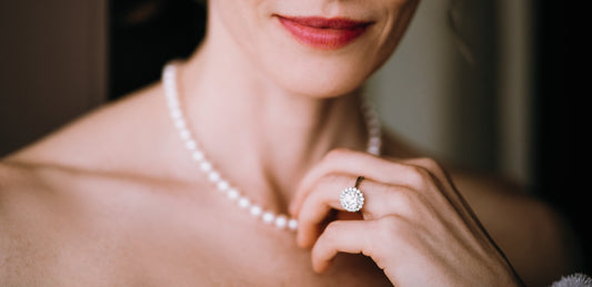 A lady with red lip wearing pearl strand