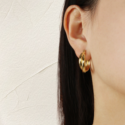 A female model wearing 18k Gold-plated Sterling Silver Hoop Earrings Charlotte 