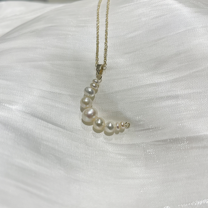 Mermaid Pearl Pendant Necklace Arista with white satin background