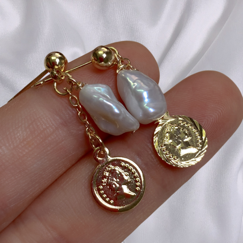 Baroque Pearl Drop Earring with Vintage Gold Coin Leanne lying on fingers image