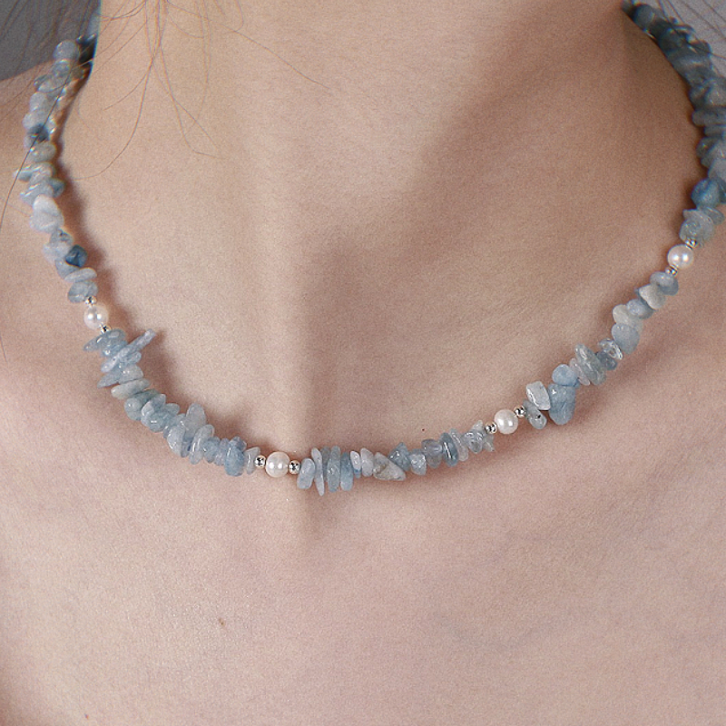 A female model wearing Freshwater Pearl and Natural Aquamarine Necklace Claire