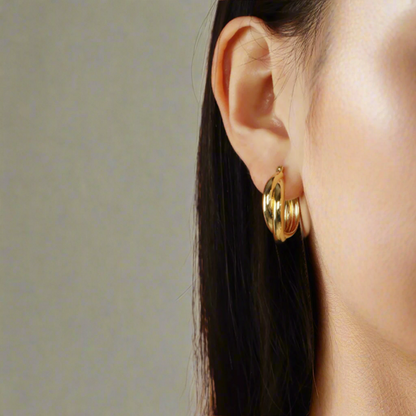 A female model wearing 18k Gold-plated Sterling Silver Hoop Earrings Charlotte 