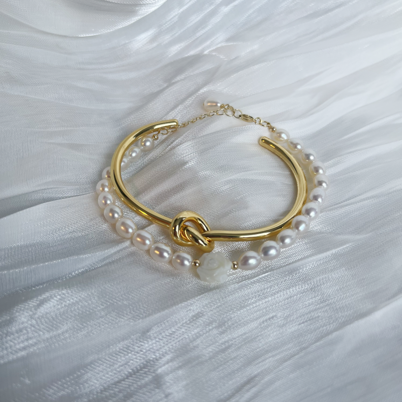 Love knot bangle with pearl bracelet studio image