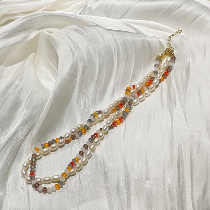 Rainbow Freshwater Pearl Double Layer Necklace Maisie lying on satin fabric studio image