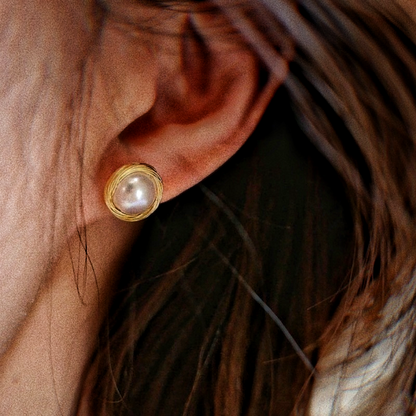 A female model wearing Bird's Nest Pearl Stud Earrings Sarah